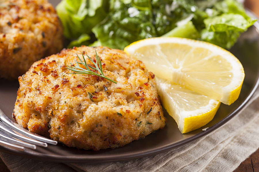 Maryland crab cakes with lemon and greens